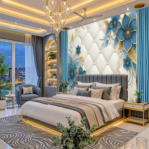 A luxury modern bedroom featuring a large blue and gold floral tufted wall mural, a gray upholstered bed with neutral bedding, a patterned gray and white rug, and a gold chandelier.